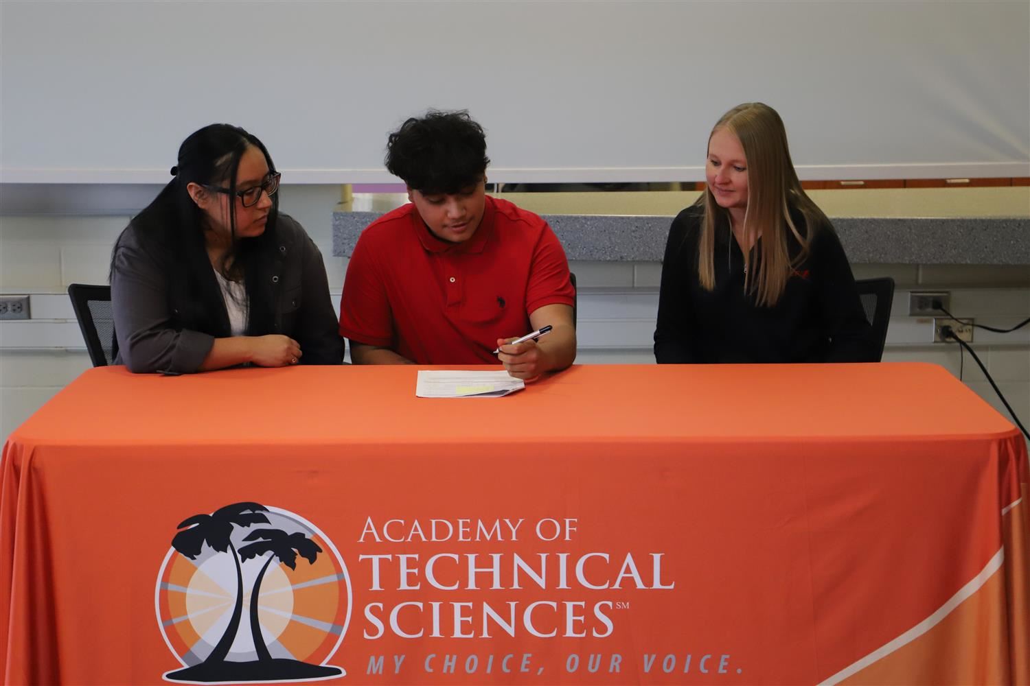 Jorge Mendoza signing for a Registered Apprenticeship with Chief Buildings